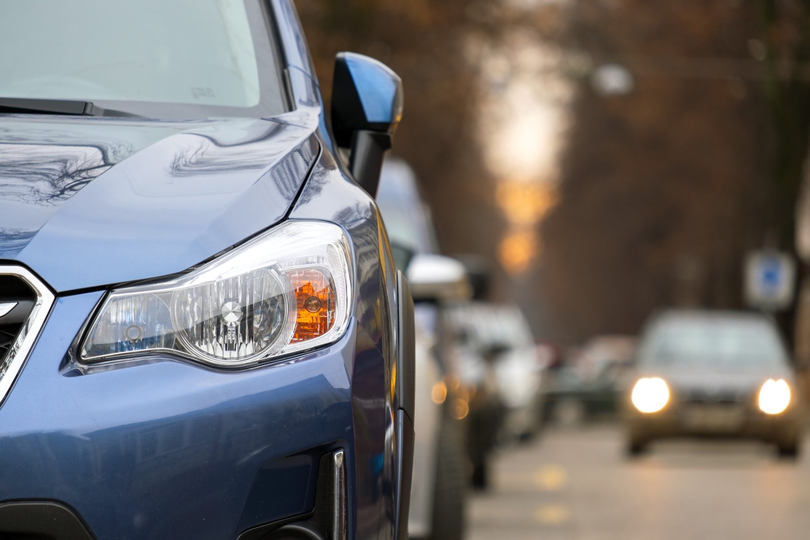 Cars parked in a row on a city street side Cars parked in a row on a city street side.